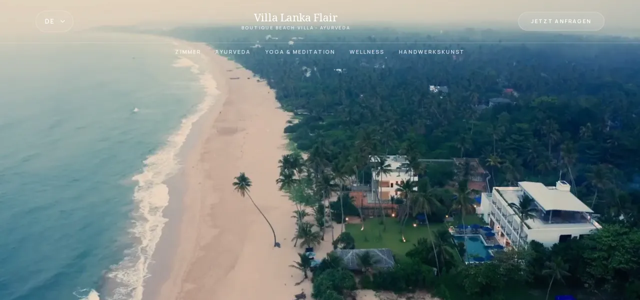 Hero of villalankaflair.com: an aerial view of the Villa Lanka Flair buildings, garden and pool beside a long palm-lined beach